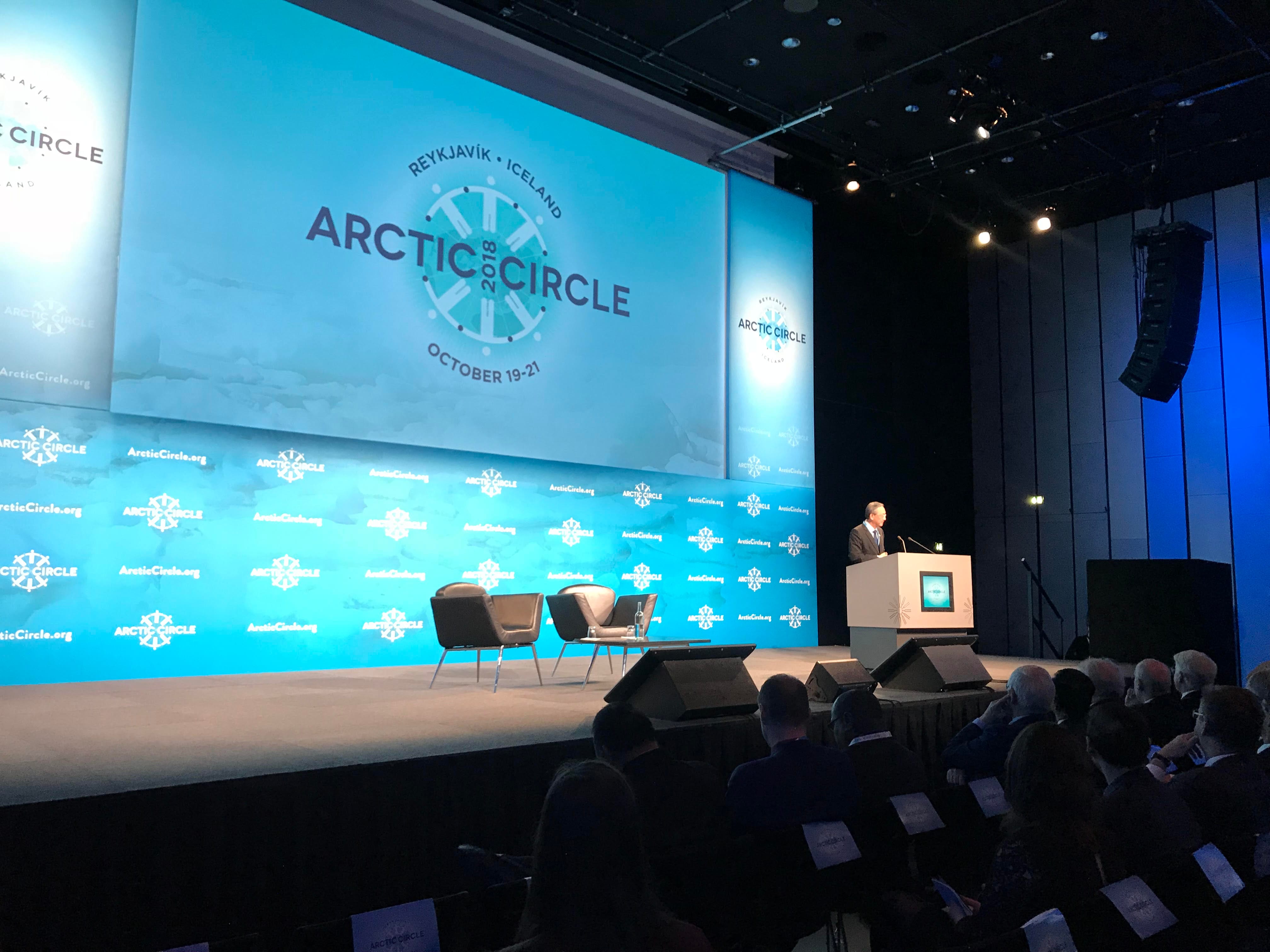 Audience seated, watching speaker on stage at the Arctic Circle conference; Reykjavik, Iceland.